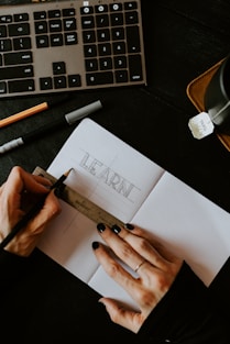 person writing on white paper