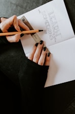 person writing on white paper