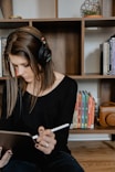 woman in black long sleeve shirt holding white tablet computer