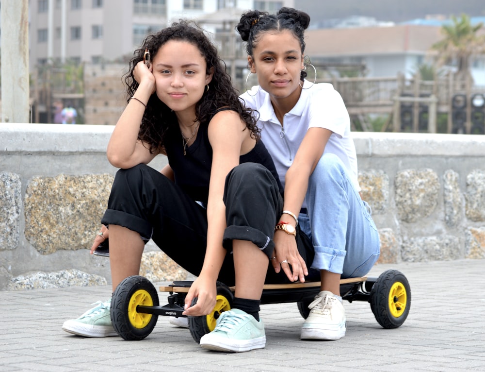 man and woman sitting on black and yellow wheel chair