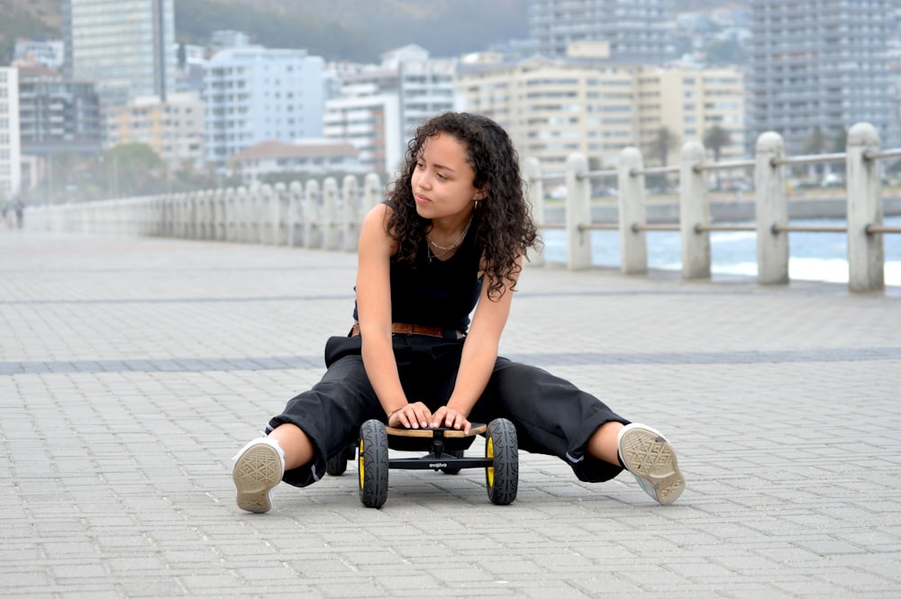 woman in black tank top sitting on black wheel chair