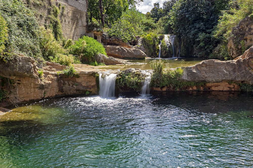 water falls on brown rocky mountain