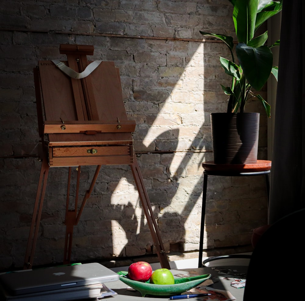 brown wooden chair beside green apple fruit