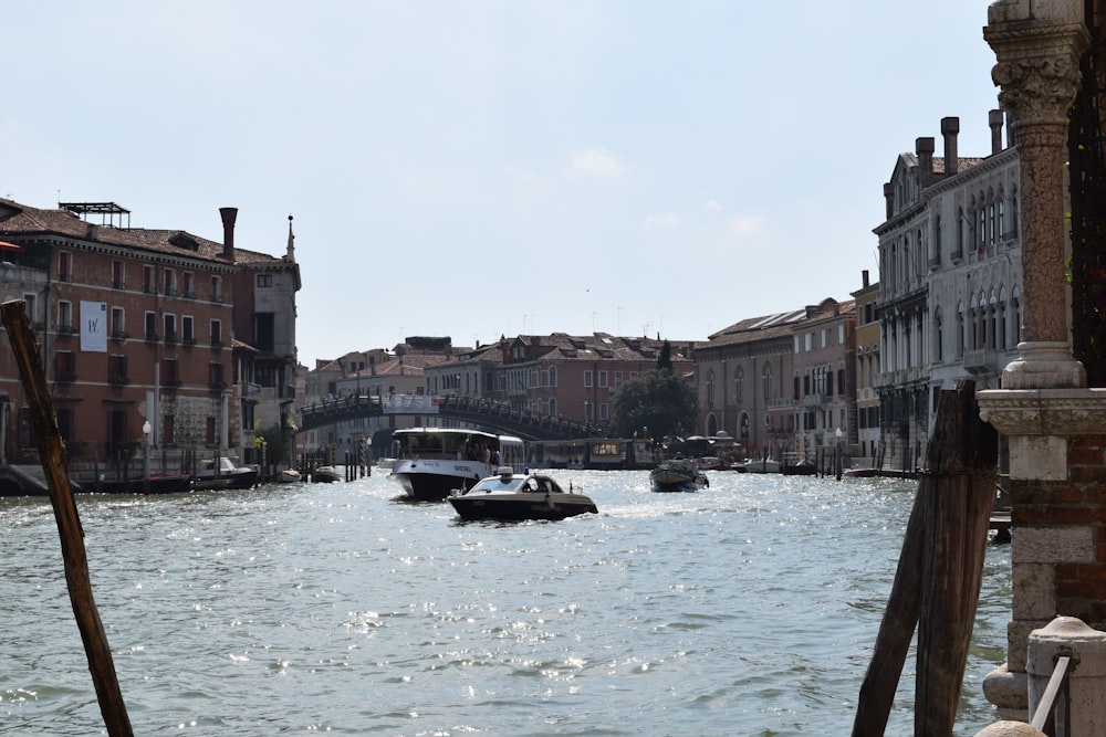 boat on water between buildings during daytime