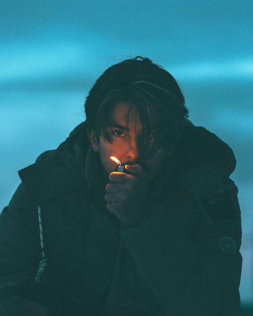 man in black jacket smoking cigarette