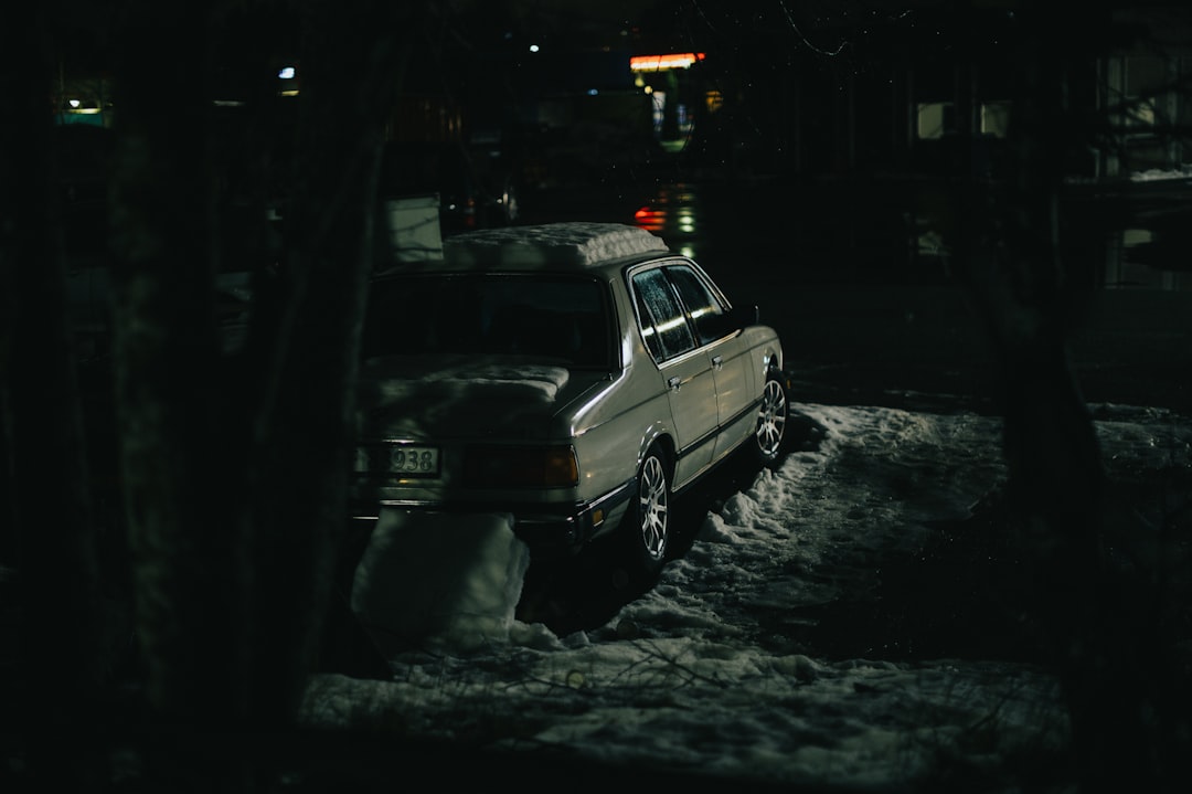 white suv on snow covered road during night time