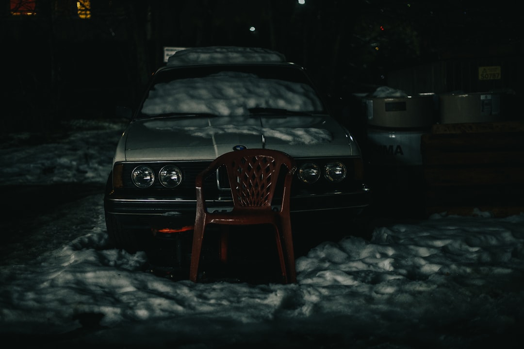 black car on snow covered ground during night time