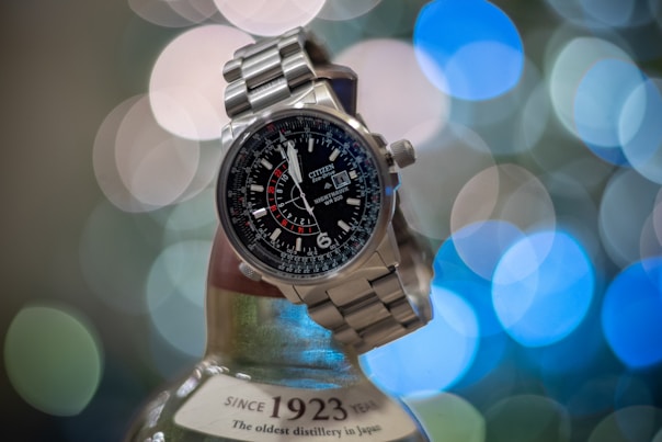 silver and black round analog watch