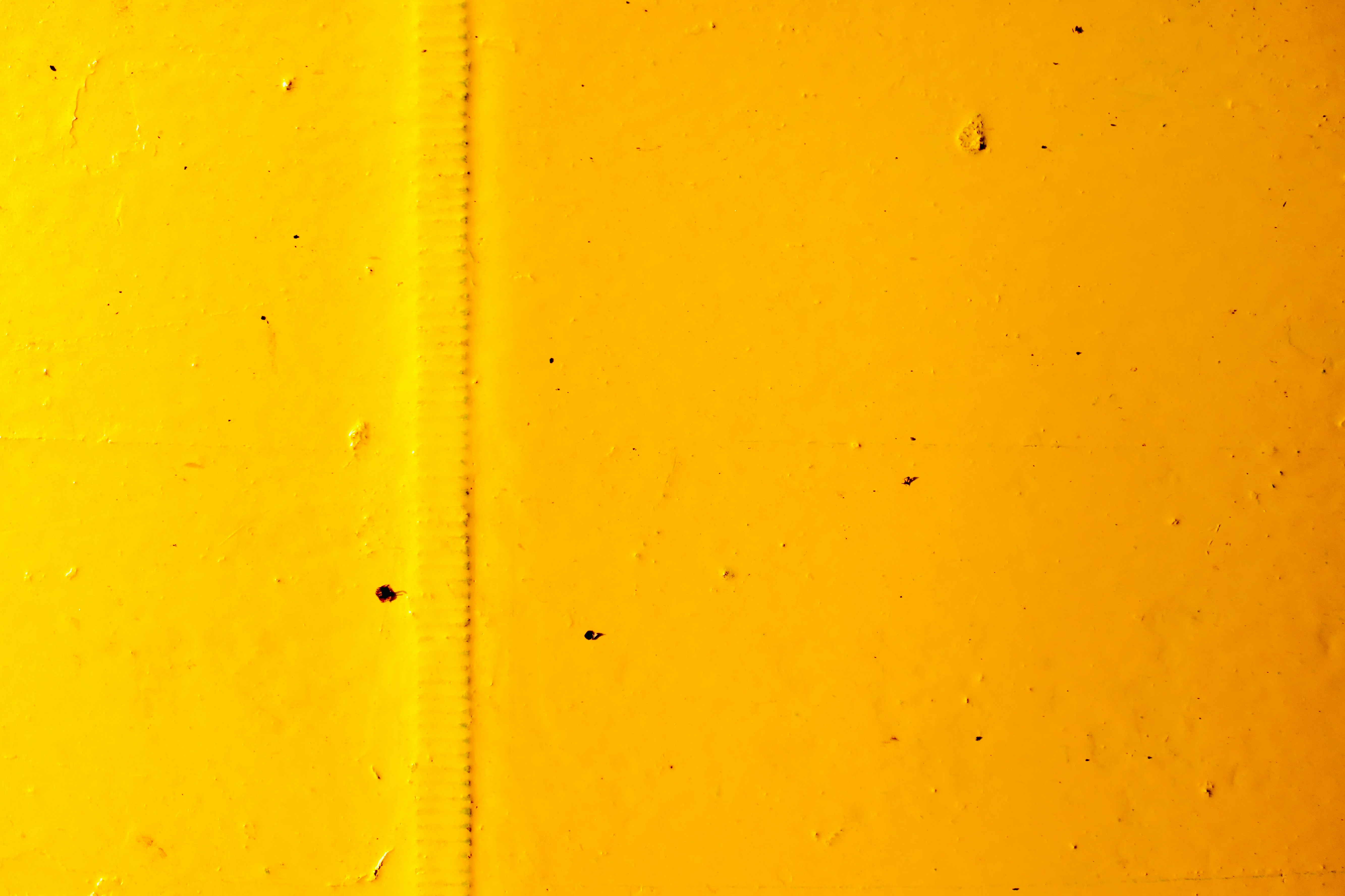 yellow painted wall with hole