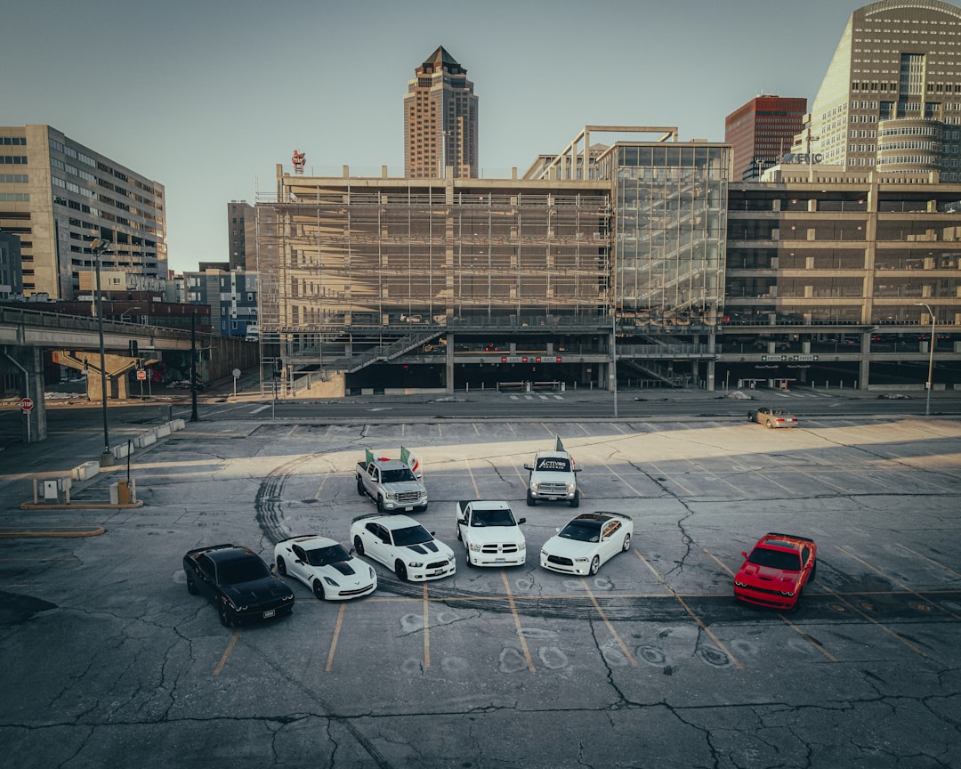 cars parked on parking lot near brown concrete building during daytime