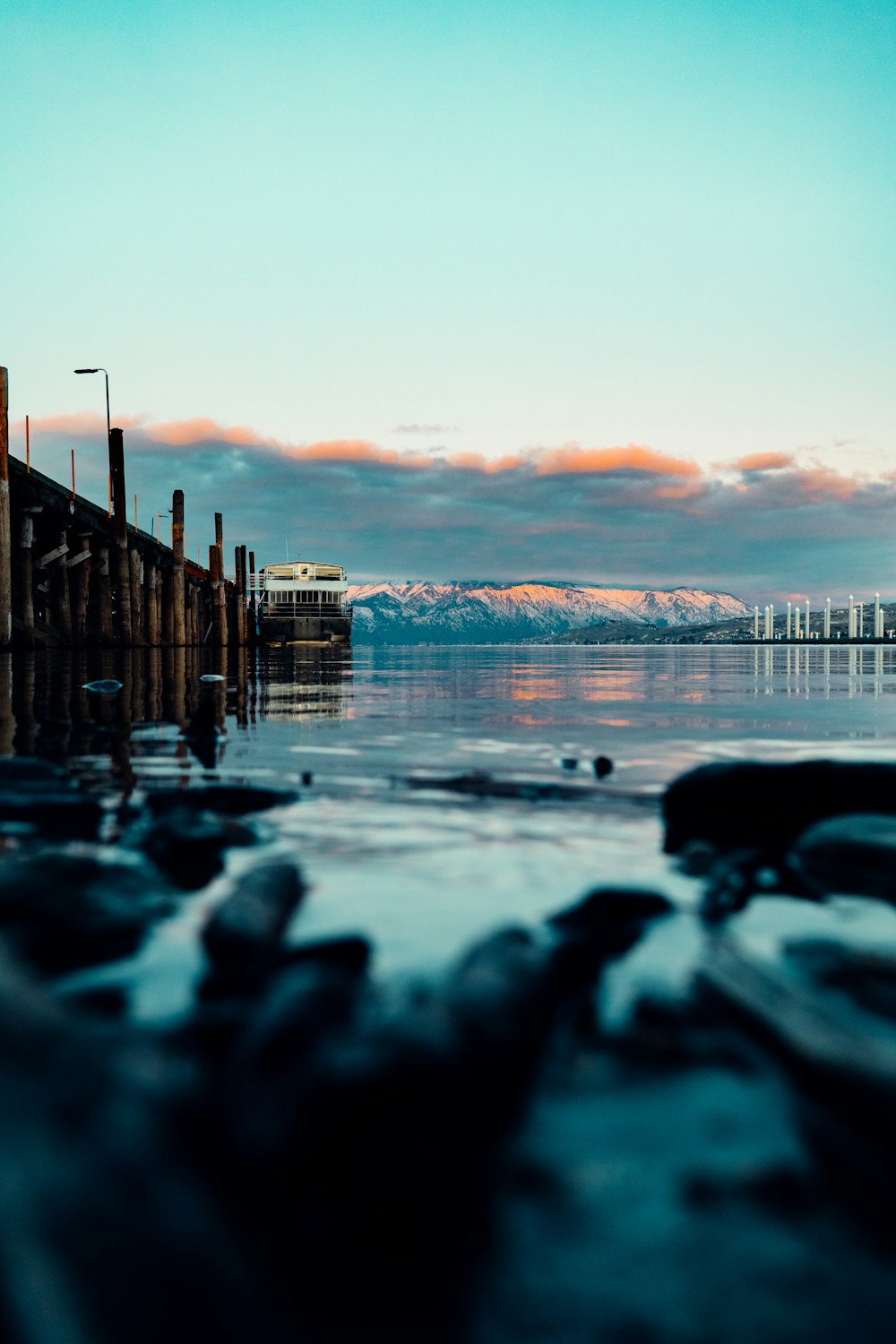 brown wooden dock on sea during sunset