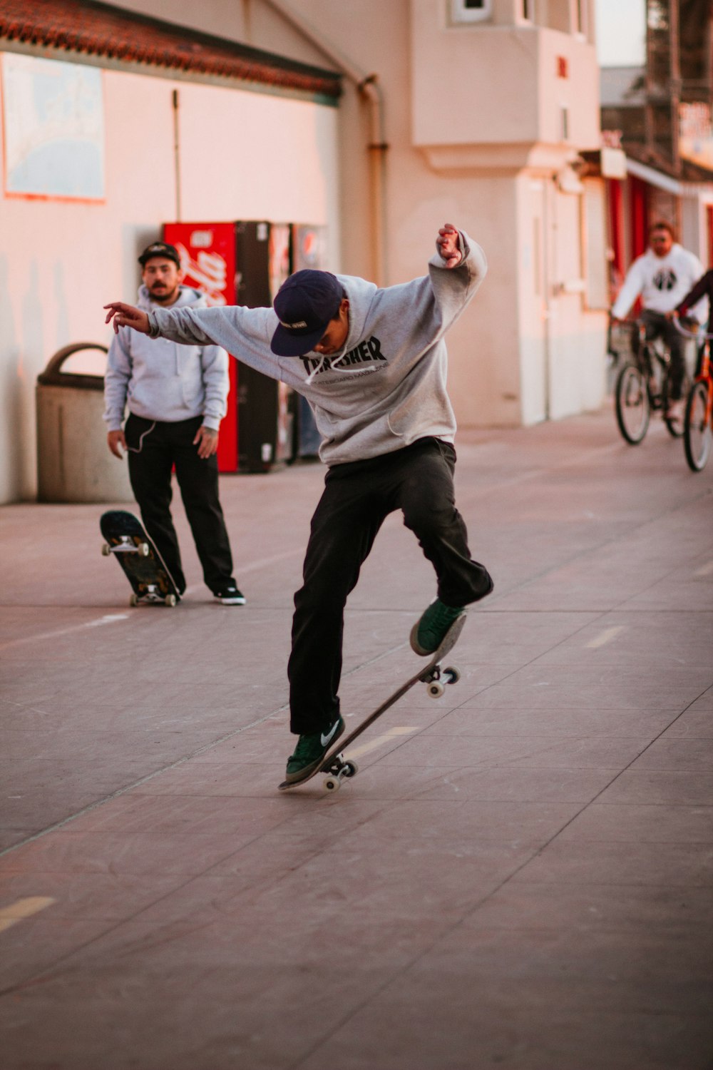 man in white long sleeve shirt and black pants playing skateboard