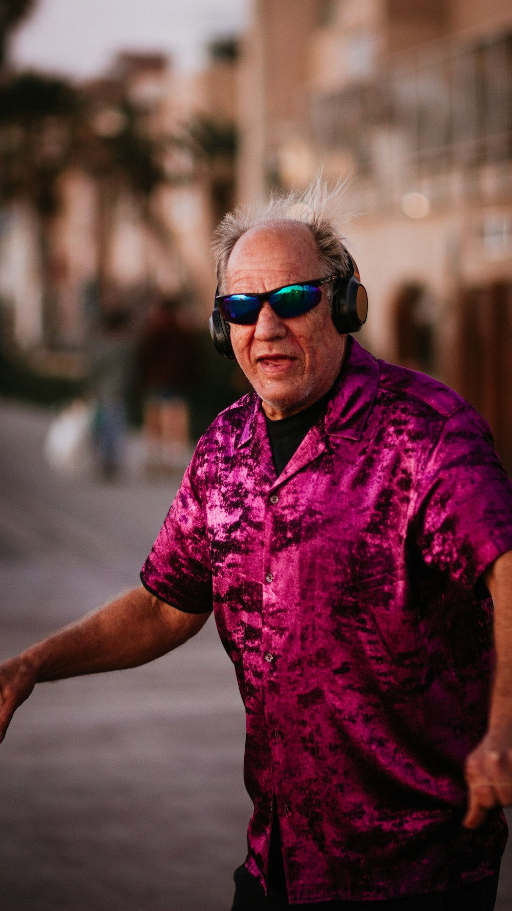 man in purple button up shirt wearing black sunglasses