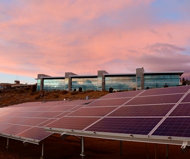 solar panels on brown field under white clouds during daytime