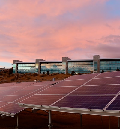 solar panels on brown field under white clouds during daytime