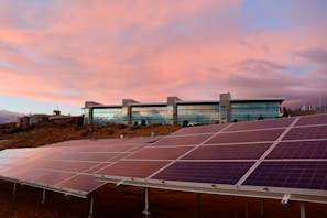 A solar-powered building with panels integrated into the facade during sunset