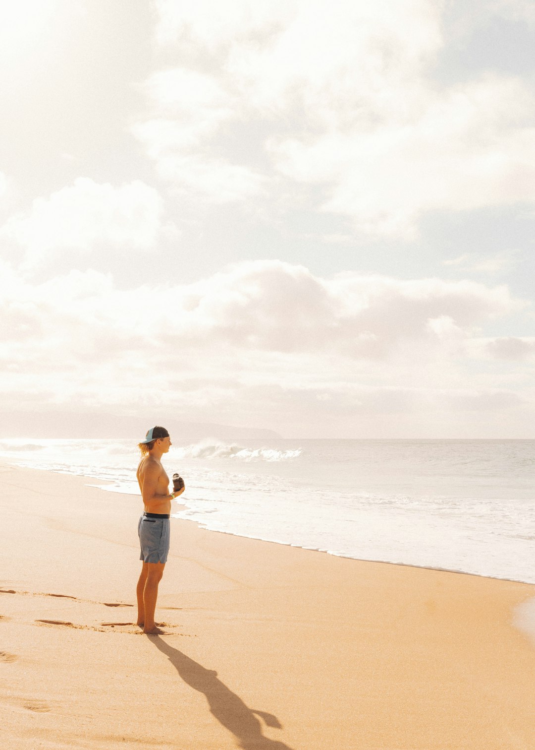 man in black shorts standing on beach during daytime