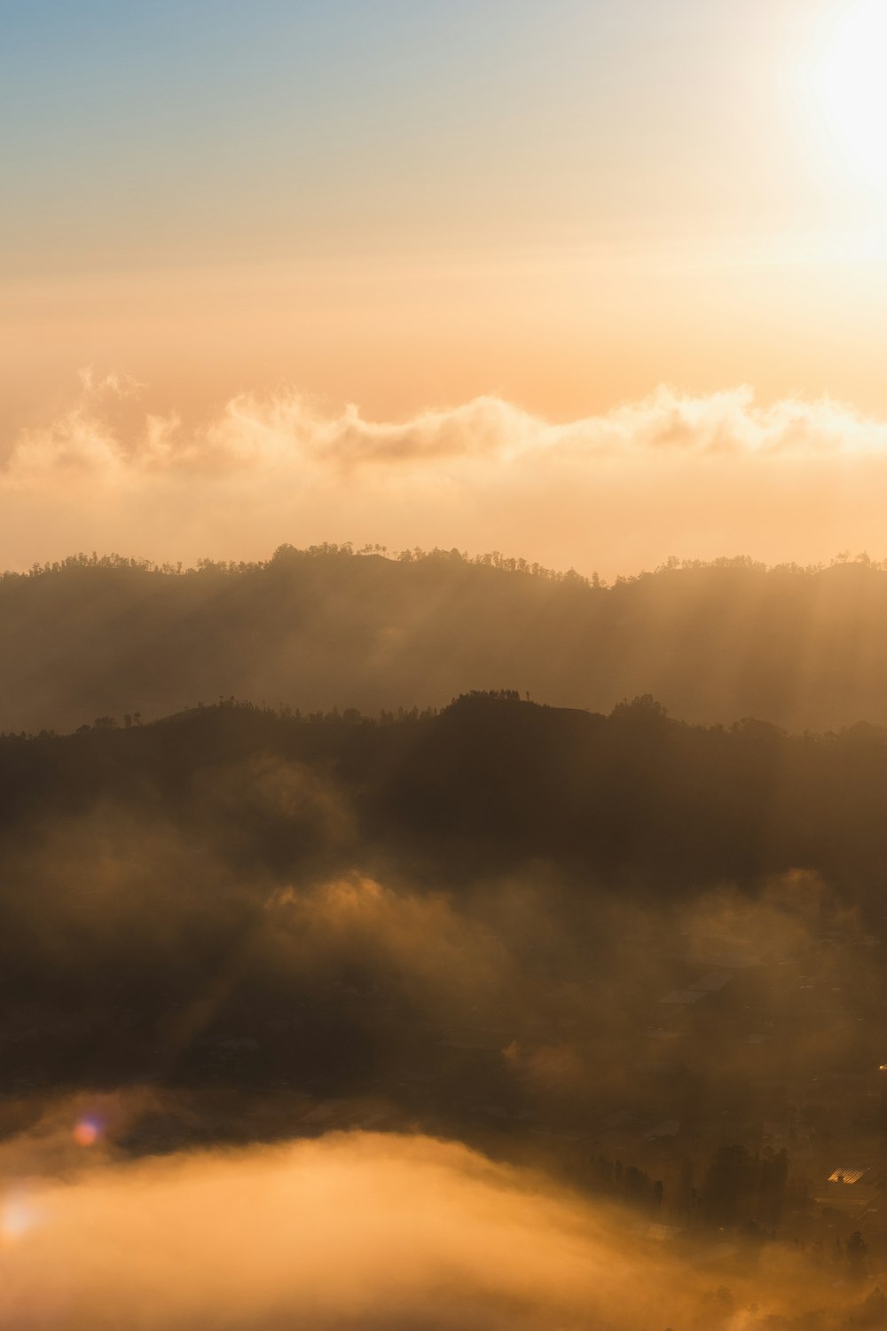 white clouds over mountains during daytime