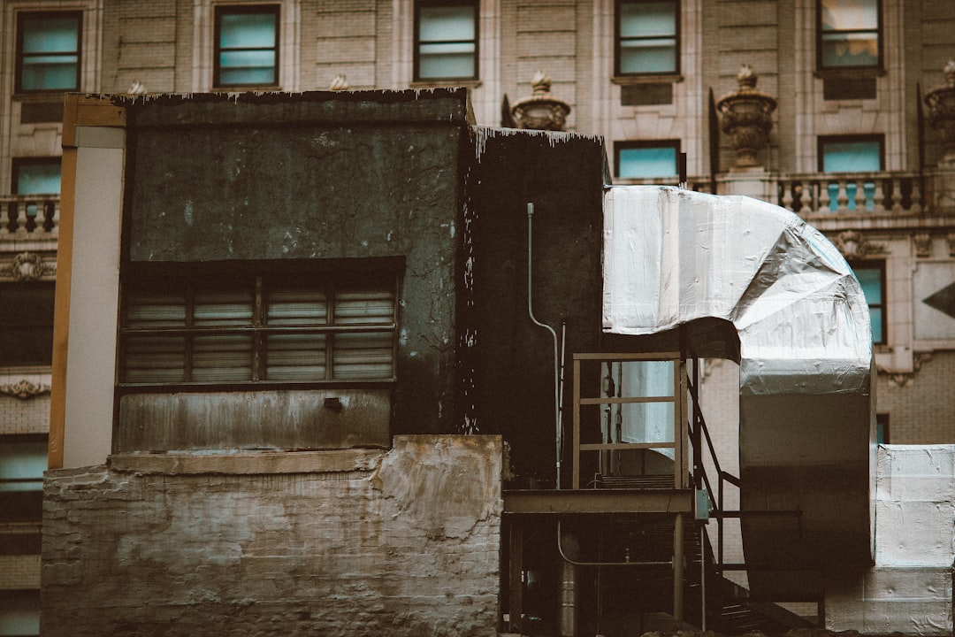 man in white long sleeve shirt standing on gray concrete stairs