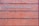 A rectangular brick wall with a sign that has the words 'Planned Parenthood' written in metal letters attached to it.