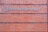 A rectangular brick wall with a sign that has the words 'Planned Parenthood' written in metal letters attached to it.