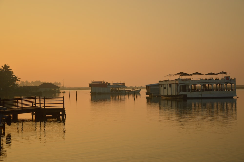 white and green houses beside body of water during daytime