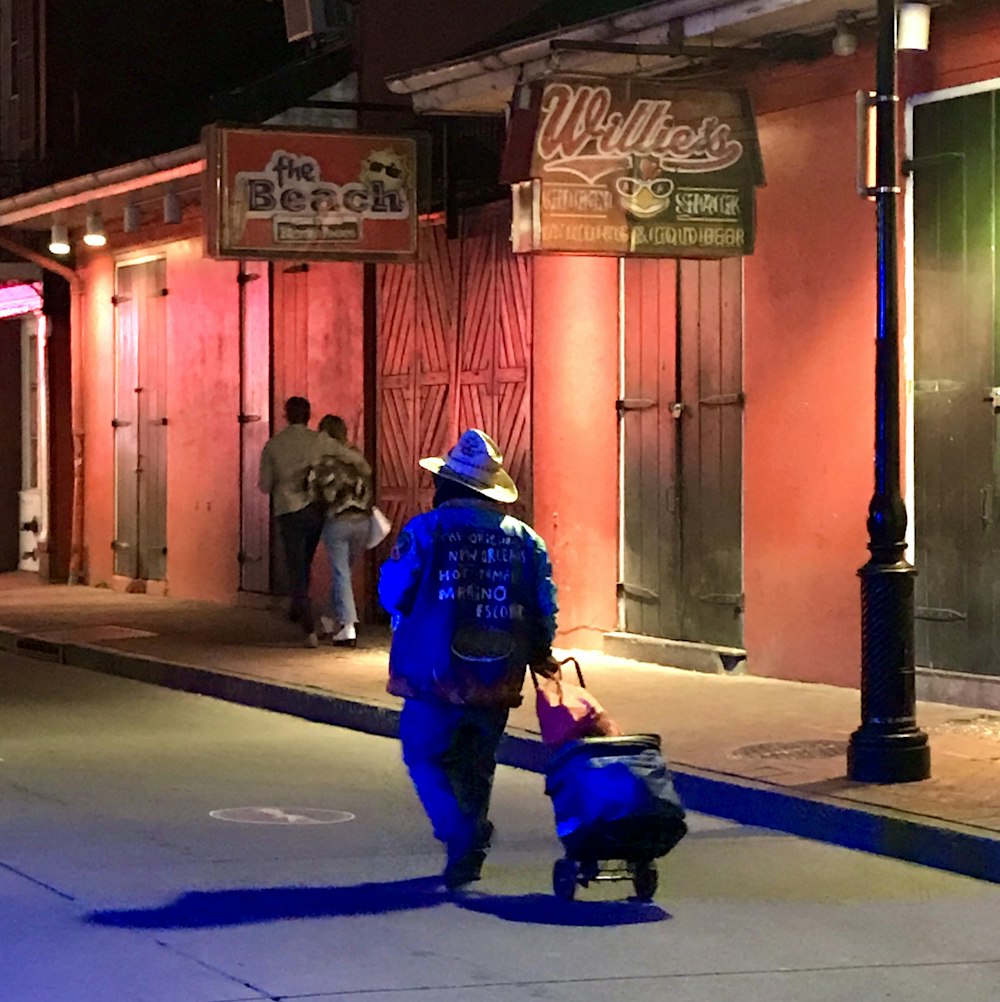 man in blue jacket riding on black motor scooter