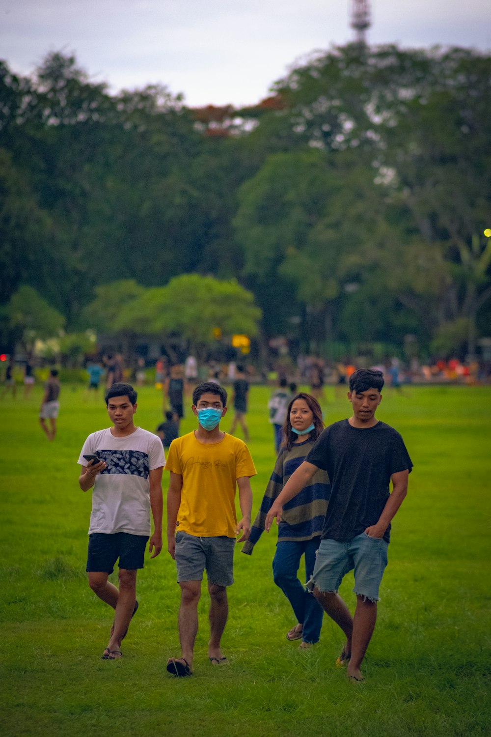 group of people standing on green grass field during daytime