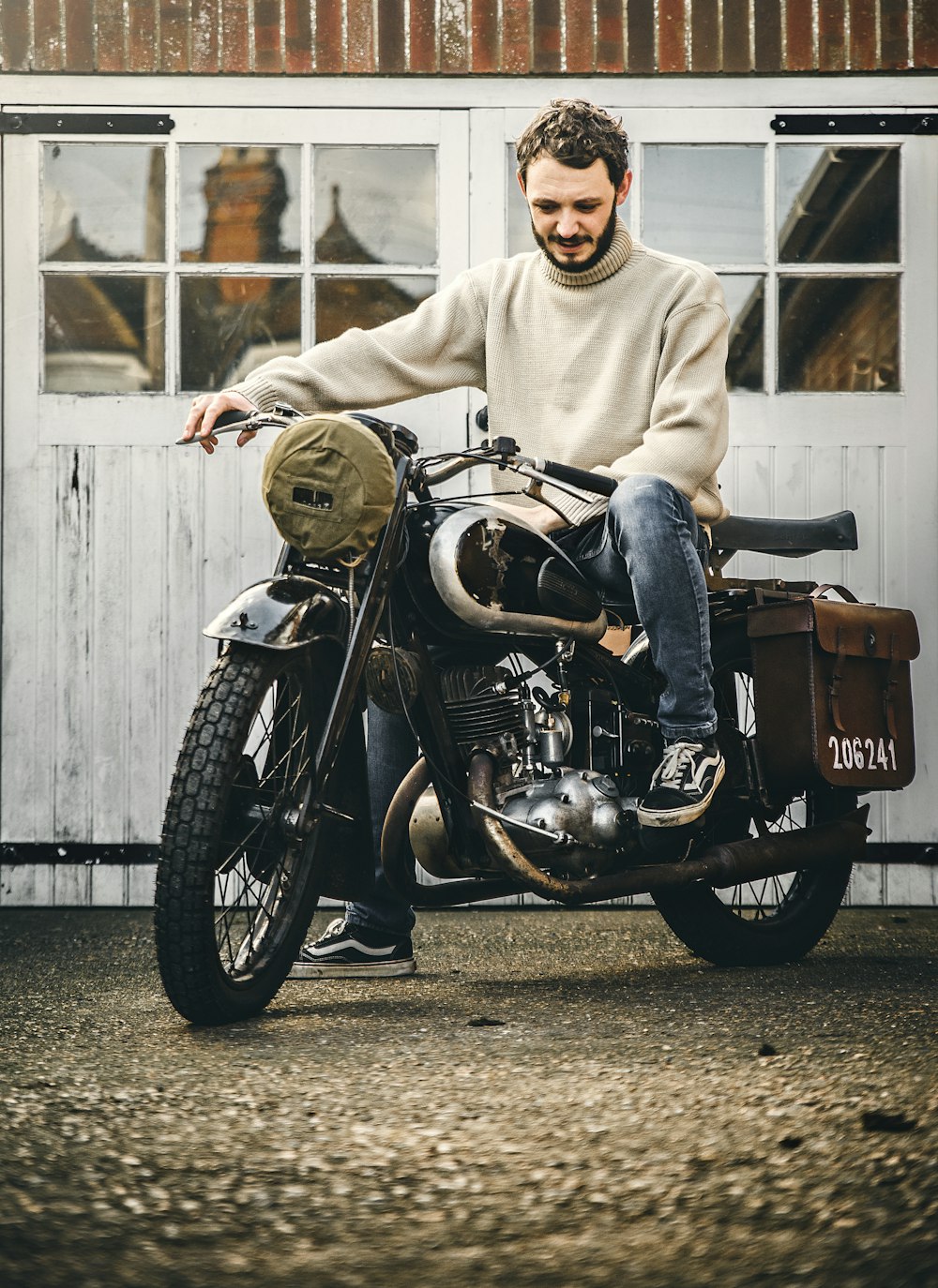 man in gray hoodie riding black and brown cruiser motorcycle