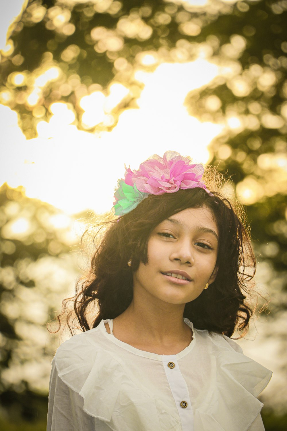 girl in white crew neck shirt with pink and white floral headband