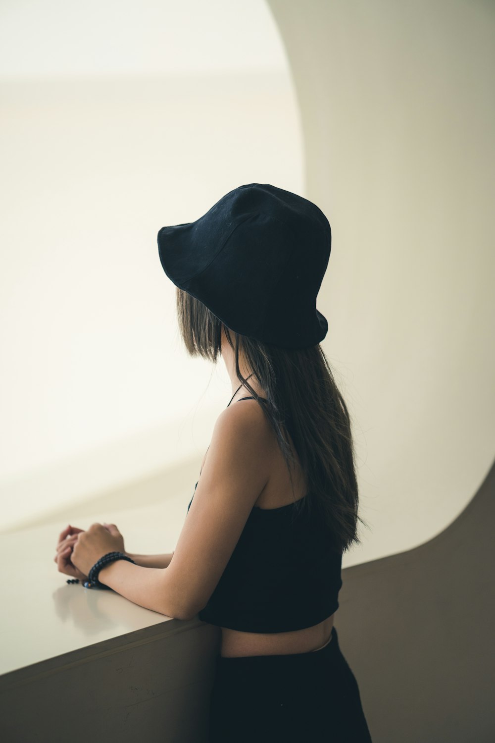 woman in black tank top wearing black hat