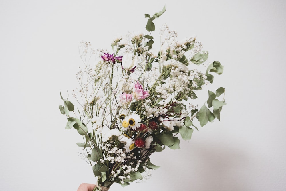 white and pink flowers in brown ceramic vase