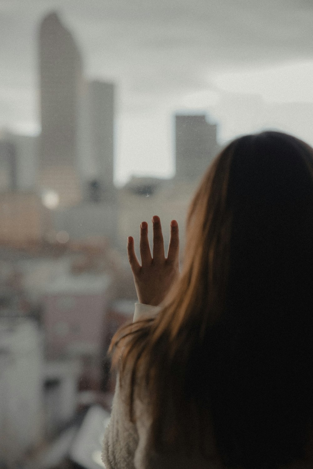 woman in white shirt raising her hands