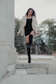 A woman walking confidently in winter attire and boots.