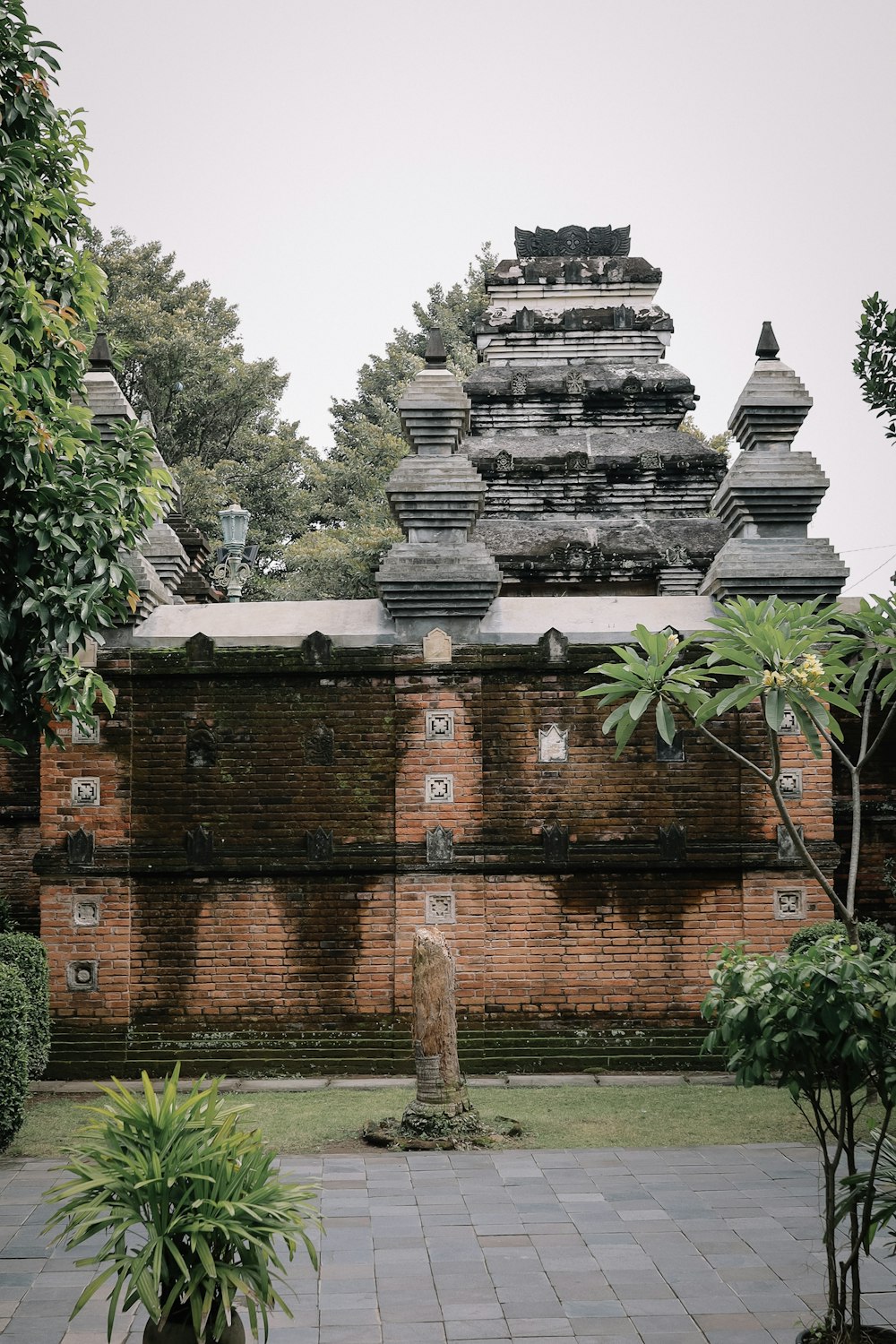 brown concrete temple near green trees during daytime