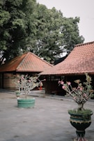 A peaceful garden courtyard surrounded by red and green themed residential buildings.