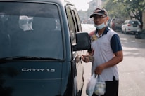 A happy customer receiving keys to their newly sourced vehicle in an African city.