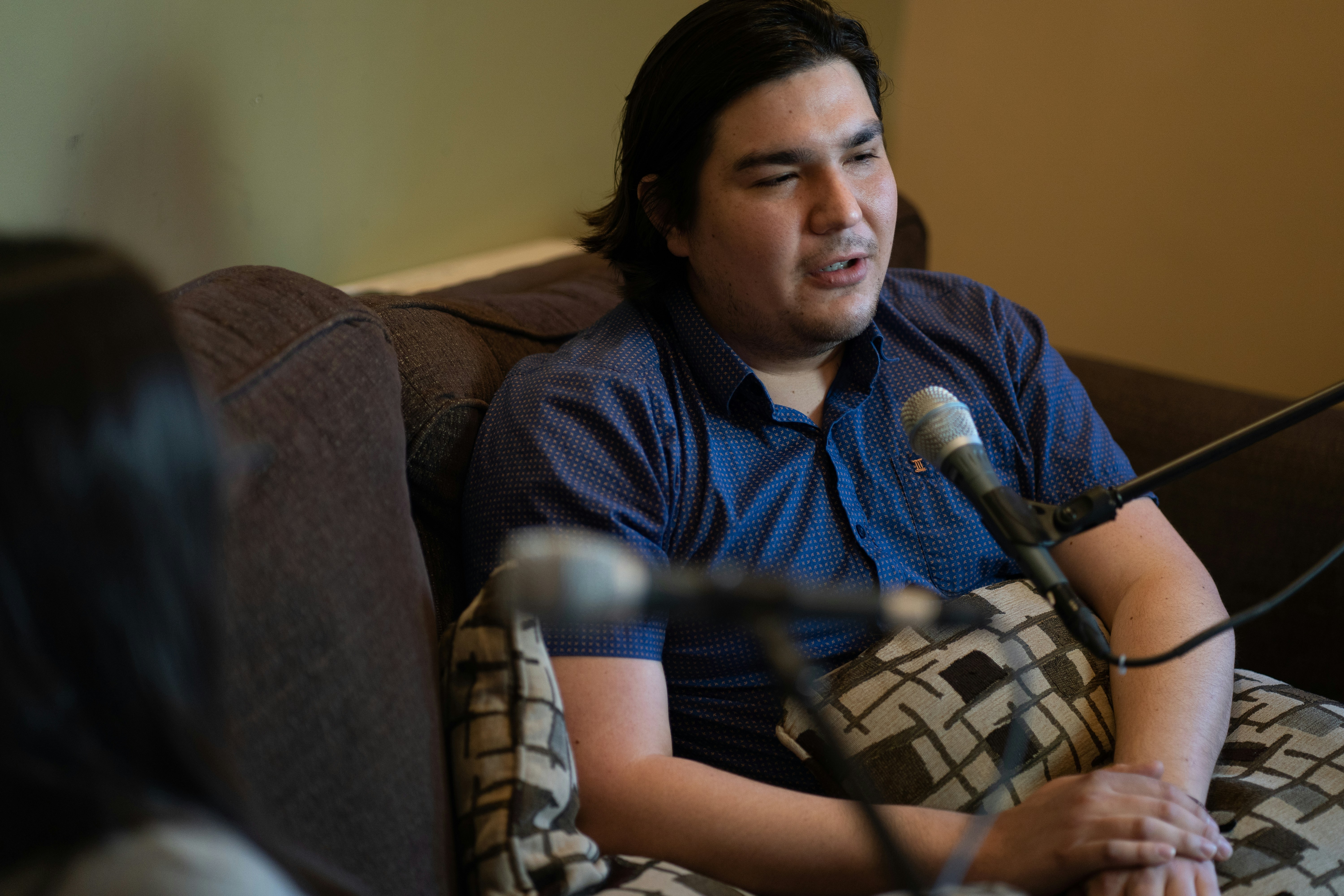 woman in black and white crew neck t-shirt sitting on brown sofa, 
