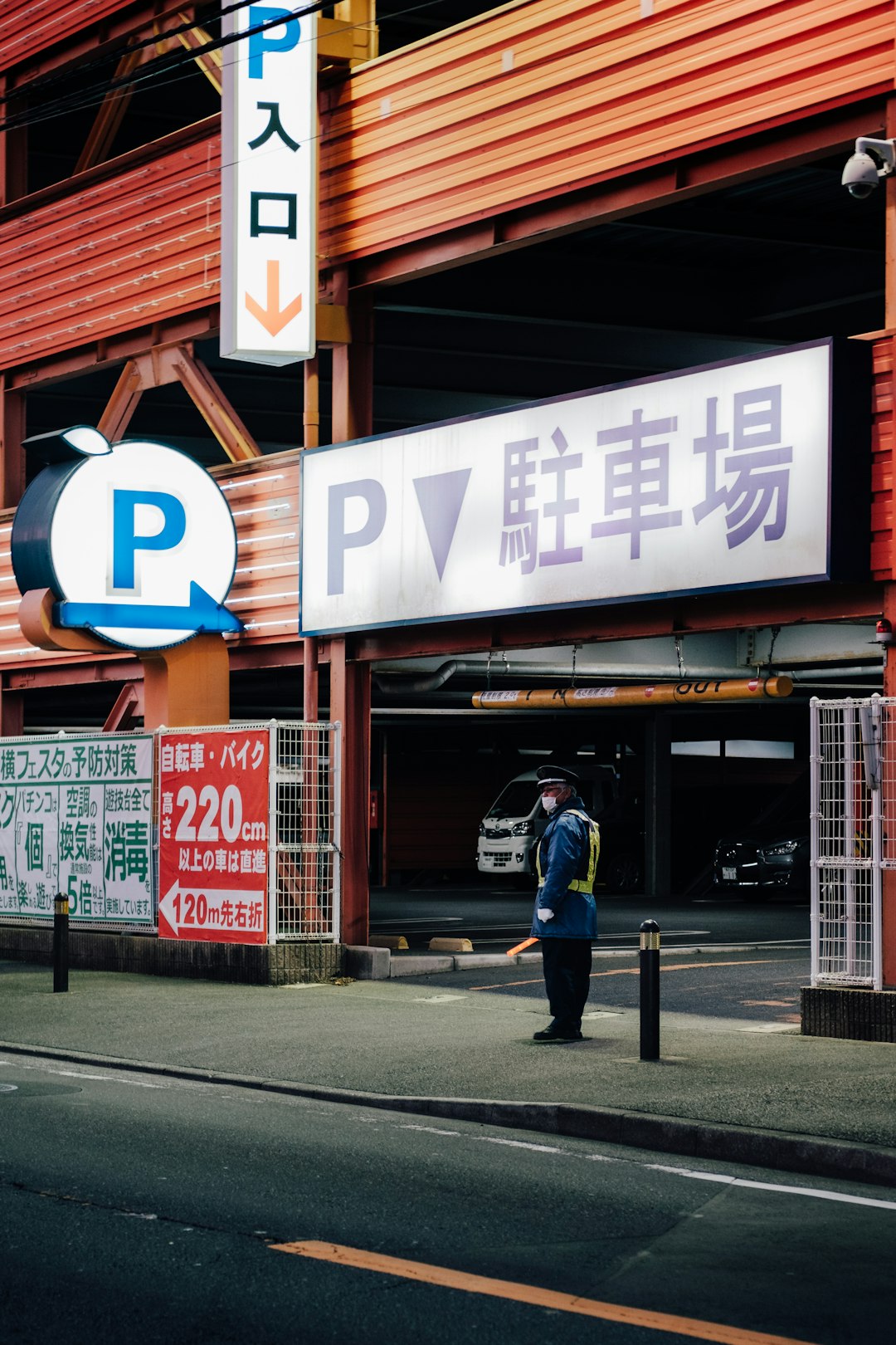 man in blue jacket and blue denim jeans walking on sidewalk during daytime