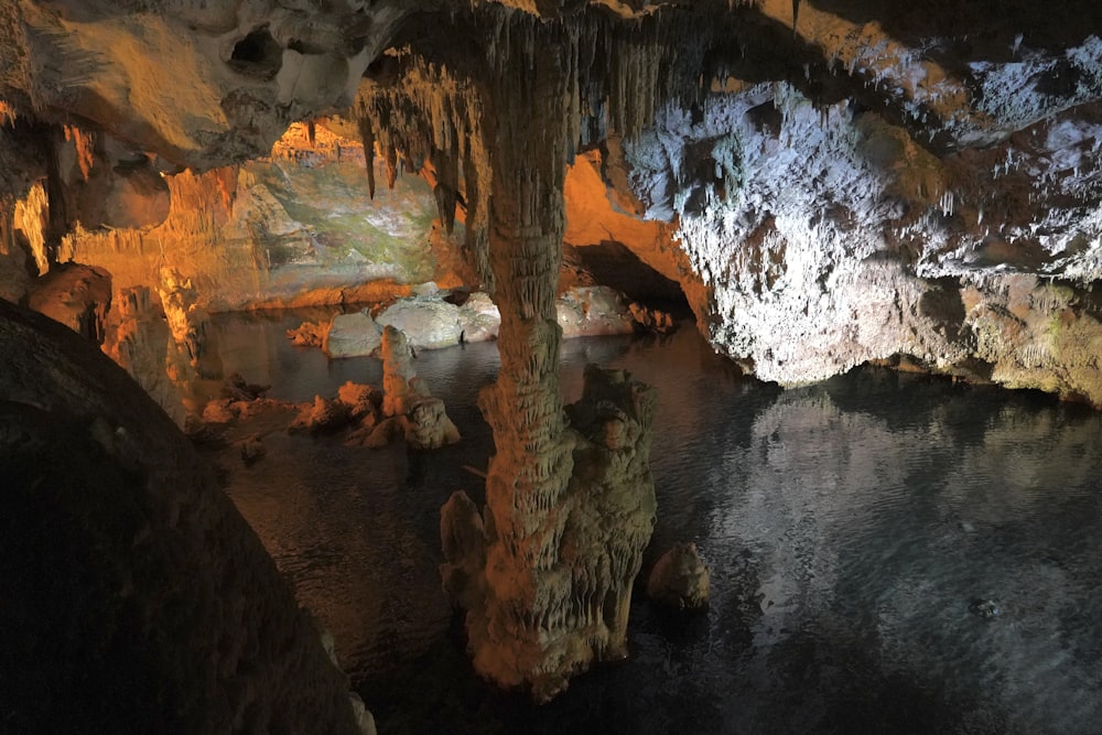 brown and white cave on water