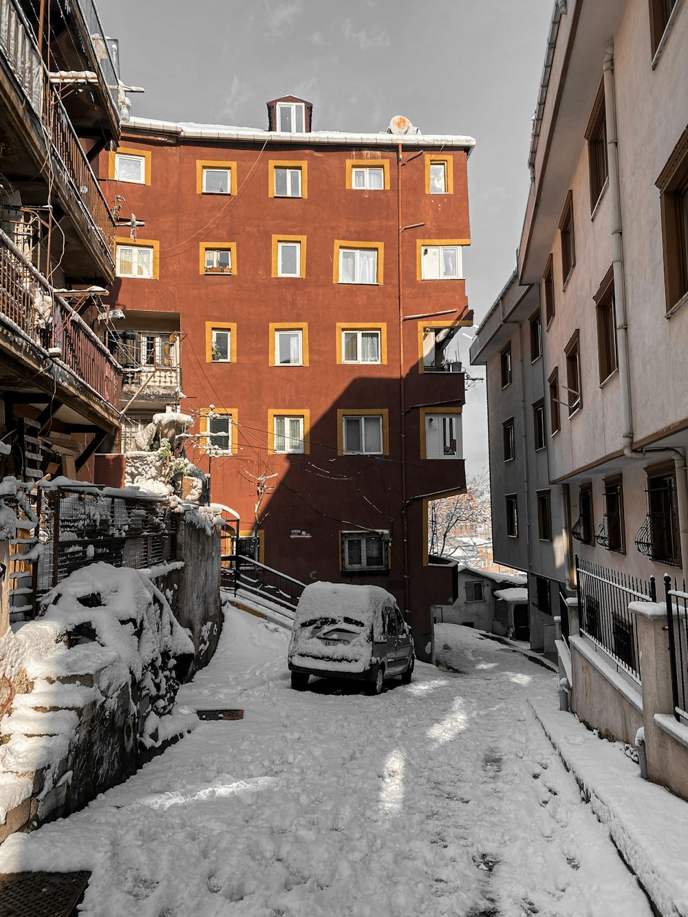 cars parked beside brown concrete building during daytime