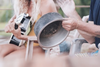 person holding black round container
