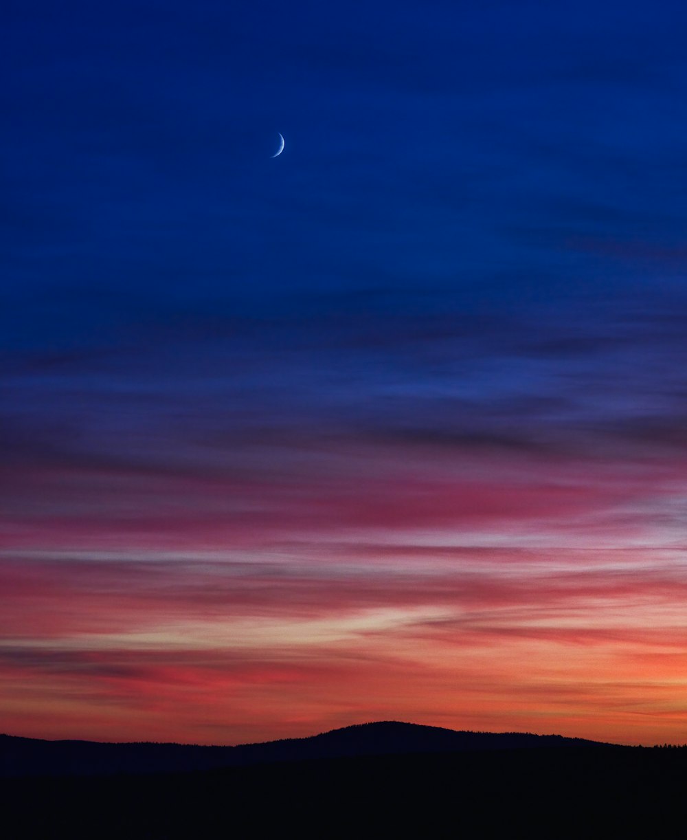 silhouette of mountain under blue sky during sunset