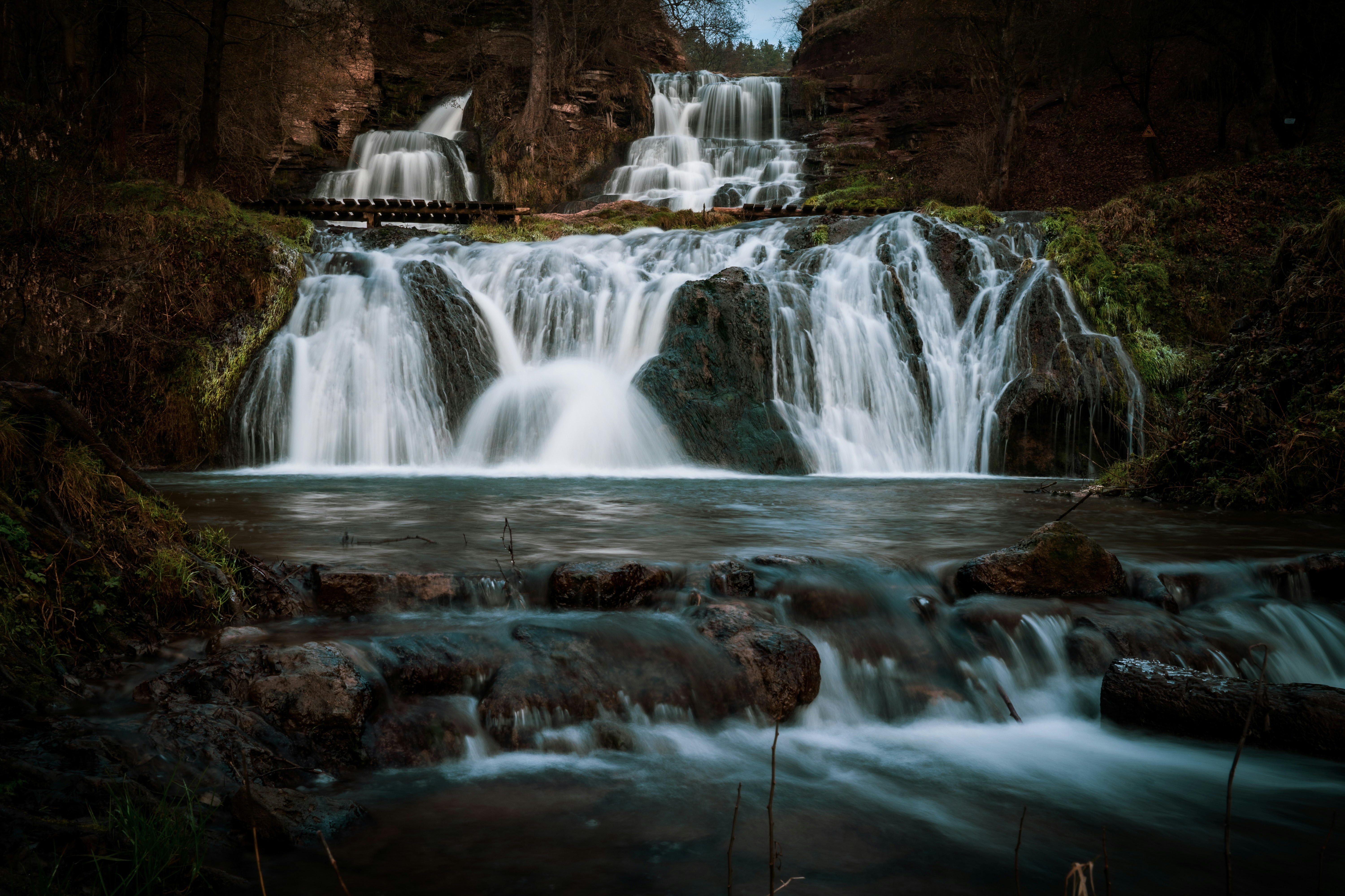 water falls in the middle of the forest
