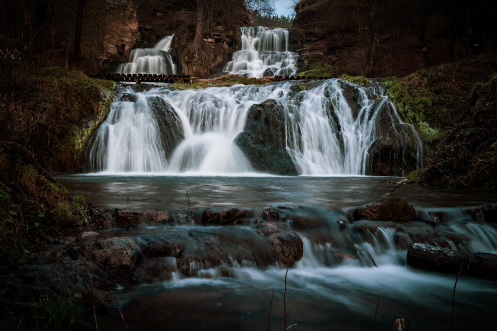 water falls in the middle of the forest