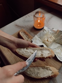 Artisan butter being spread on a slice of bread.