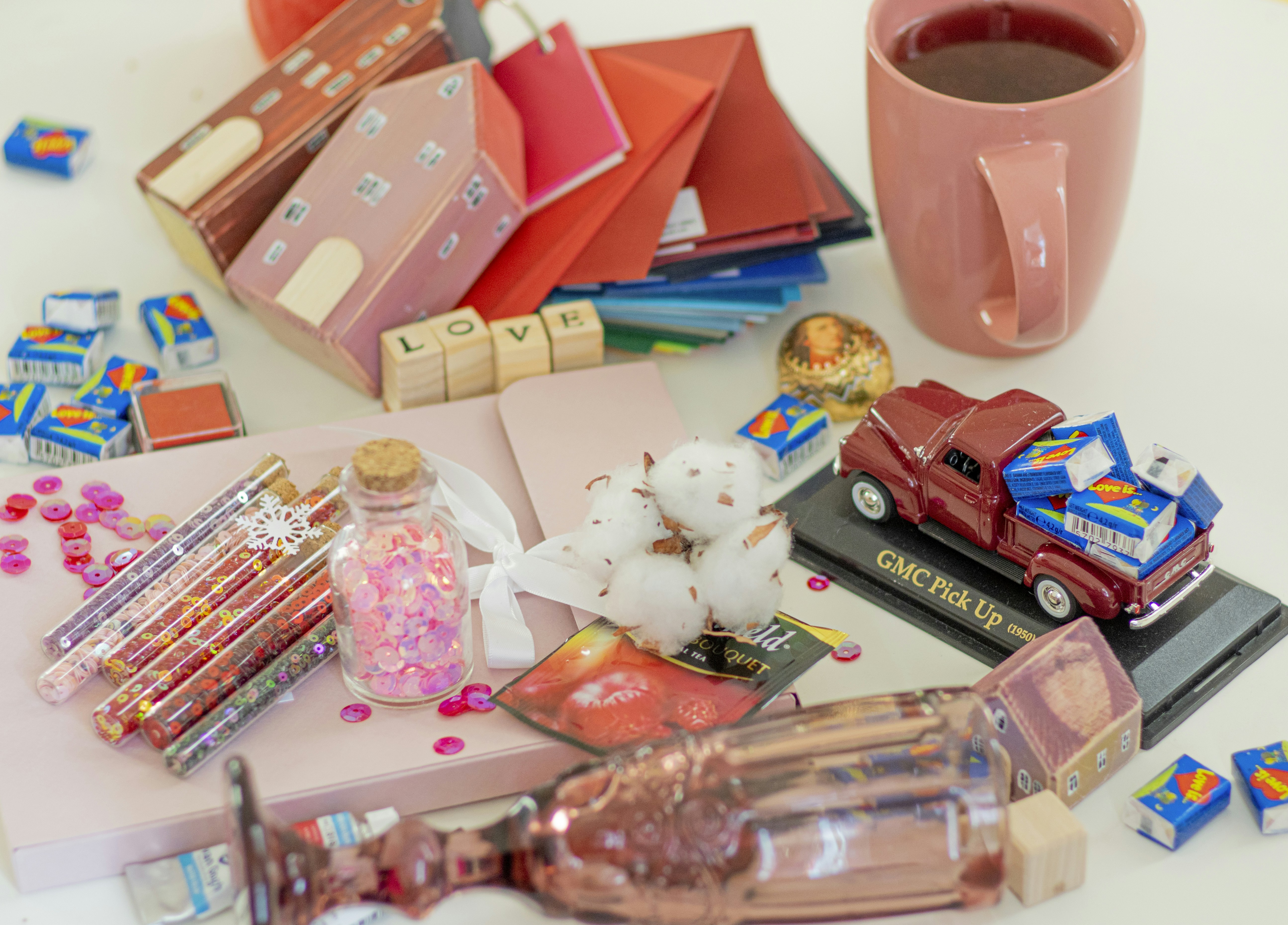 pink ceramic mug beside clear plastic container