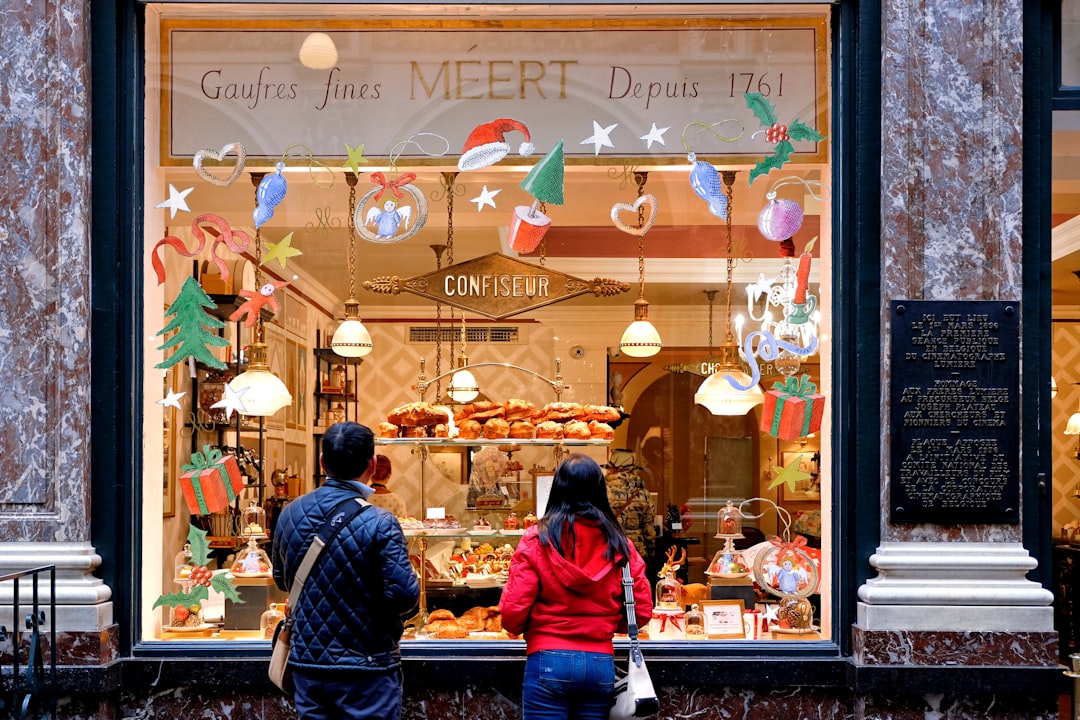 man in red jacket standing in front of store