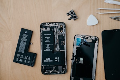 Selection of iPhone internal components including cameras and flex cables.
