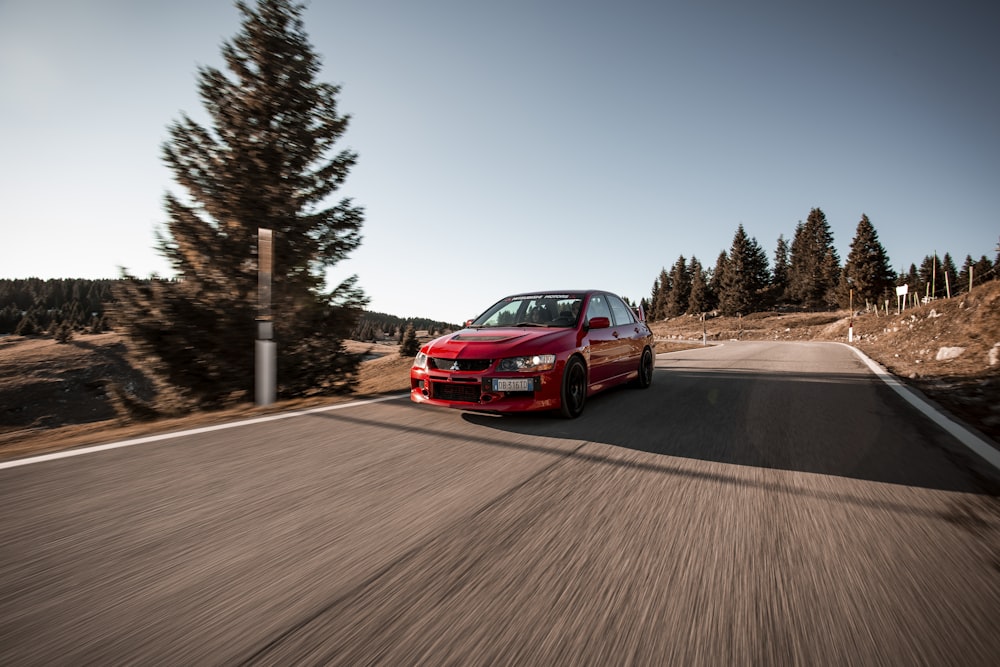 red car on road during daytime